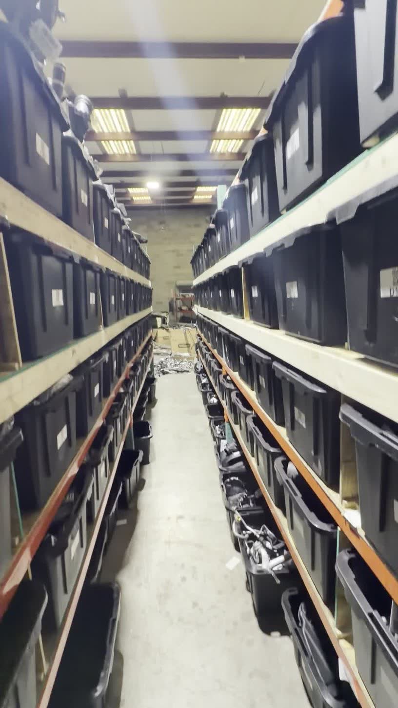 Aisle of labeled shelves with parts