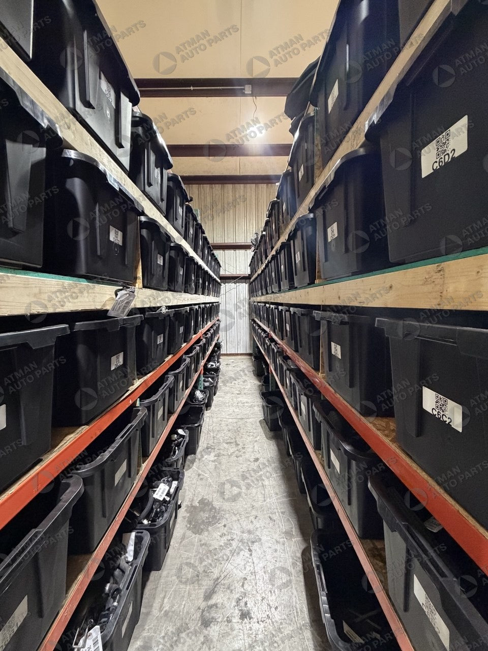 Atman Auto Parts warehouse — labeled and barcoded parts bins on shelving