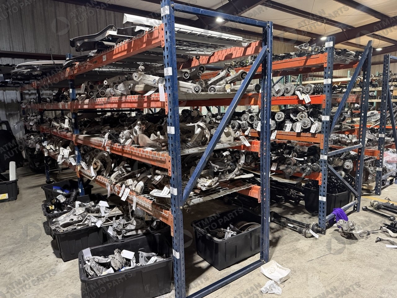 Organized used OEM BMW parts on racking in the Atman Auto Parts warehouse