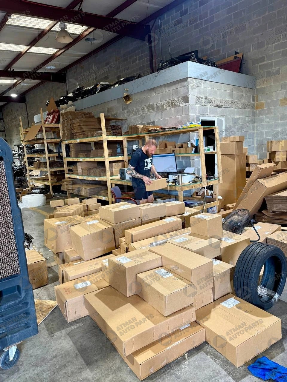 Orders boxed and labeled for shipping at Atman Auto Parts