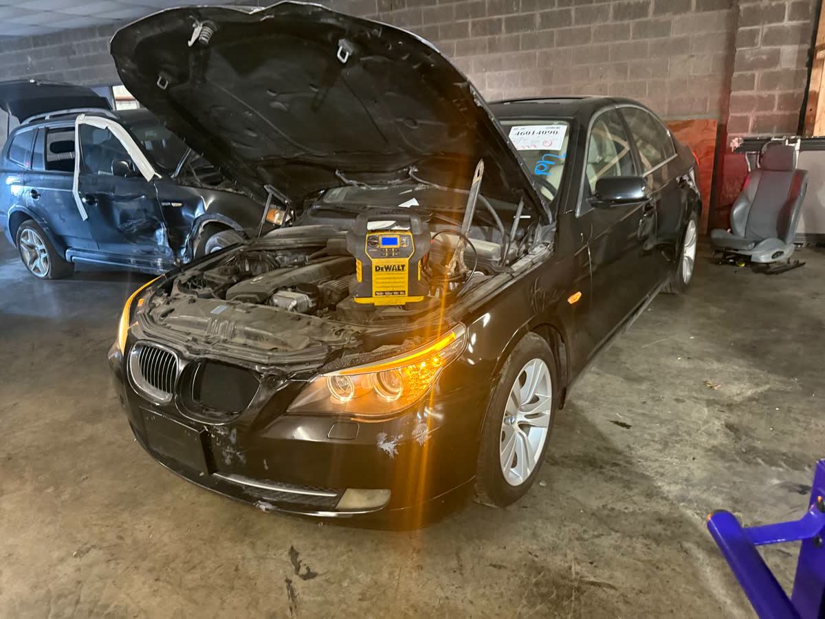 Black BMW donor car with the hood open at the Atman yard in Kaufman, Texas